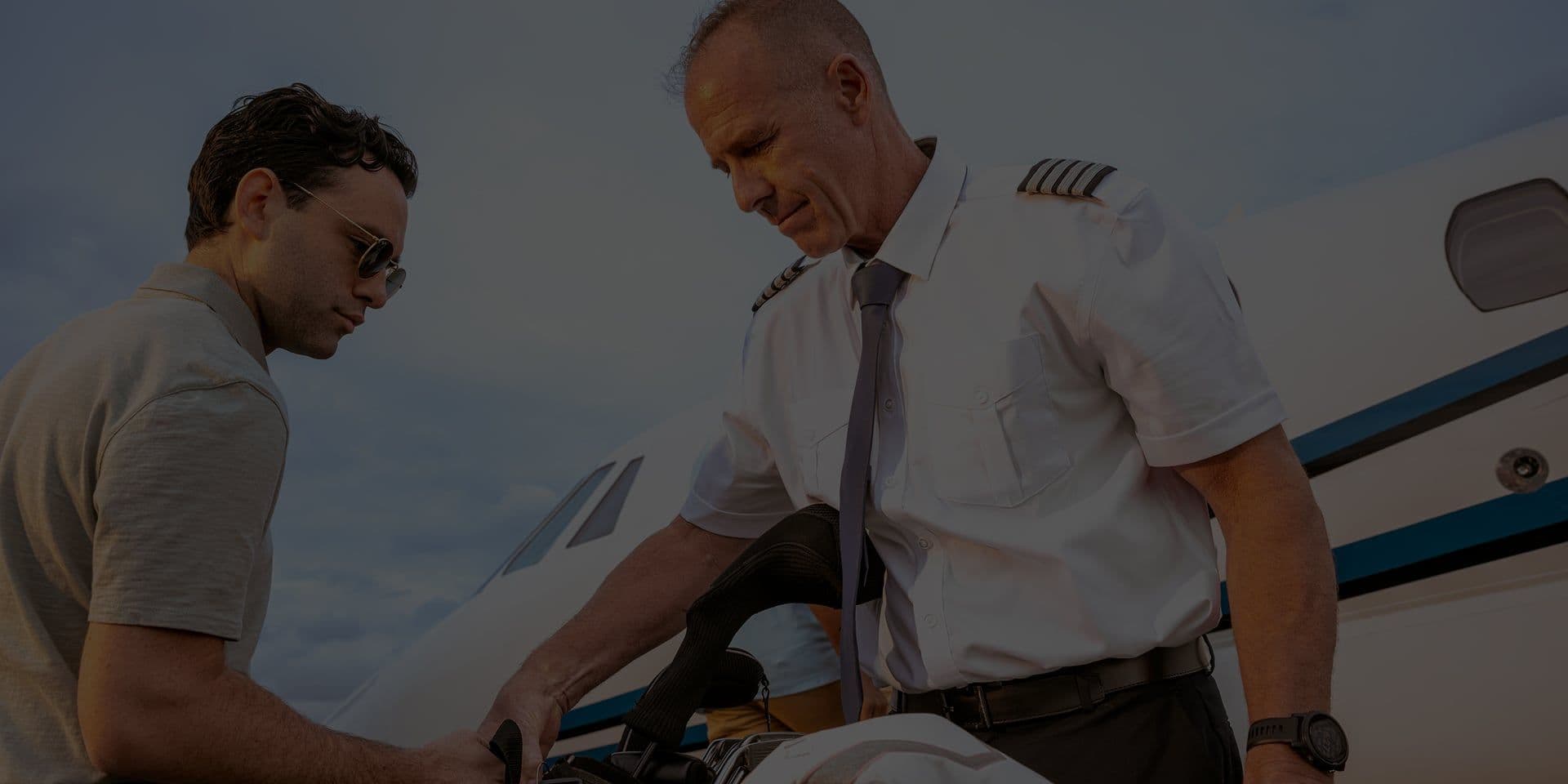 A man helping a passenger with bags